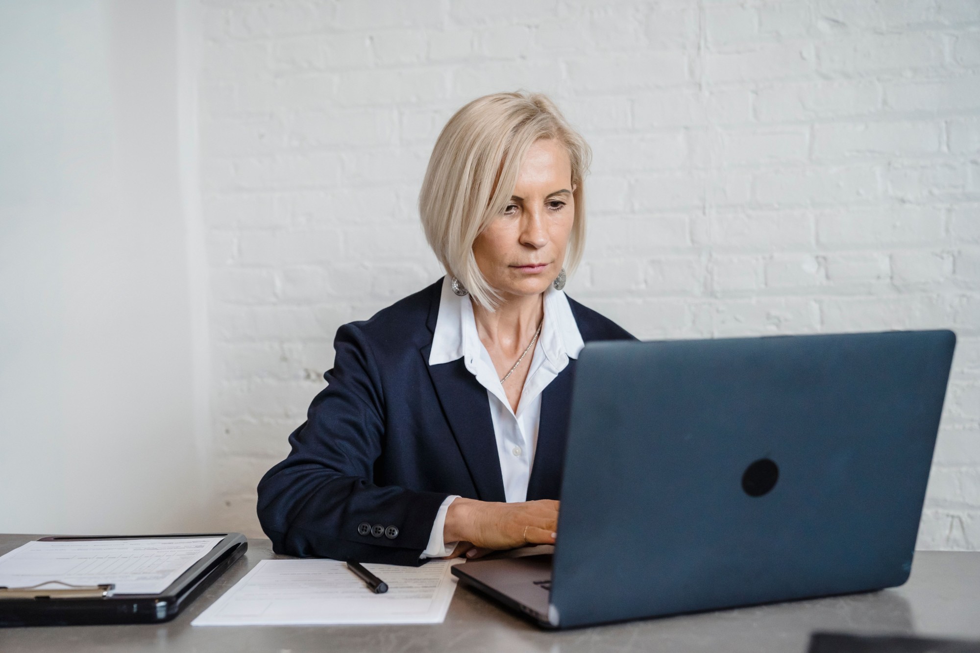 School administrator reviewing compliance records on a laptop
