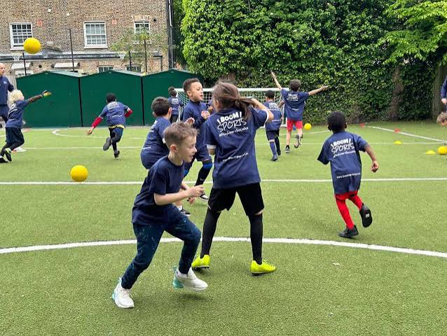 Children taking part in a Boom Sports coaching session at a London school